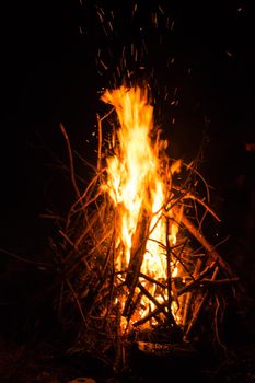 Firecamp at the night time. Hot fireplace full of wood and fire burning, closeup