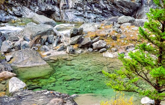 Mountain river. Stones and water of a mountain river. The mountains are said.