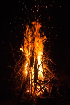 Firecamp at the night time. Hot fireplace full of wood and fire burning, closeup