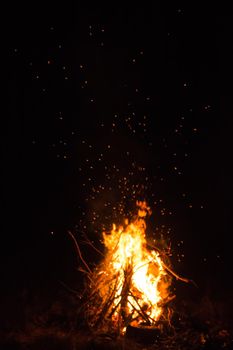 Firecamp at the night time. Hot fireplace full of wood and fire burning, closeup