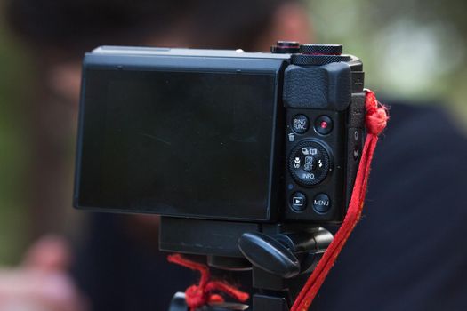 Digital camera shooting in the forest with blurry person in background