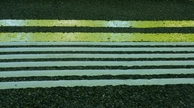 Line of hazard warning tactile paving along the edge of platform at the train station