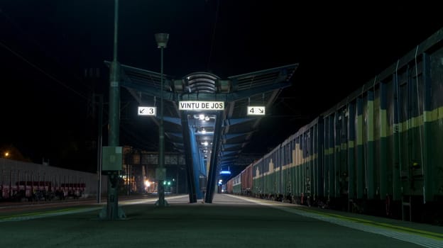 Train station with cargo train on line. Freight train