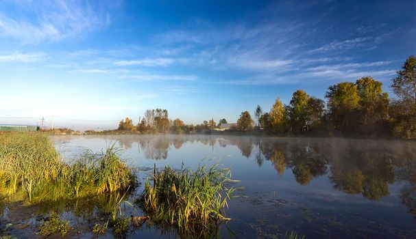 Lakes in the autumn forest. Forest autumn landscape, beautiful nature.