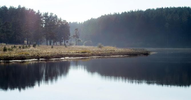 Lakes in the autumn forest. Forest autumn landscape, beautiful nature.