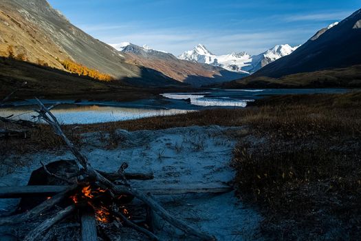 A bonfire on the banks of the Altai Mountain River.