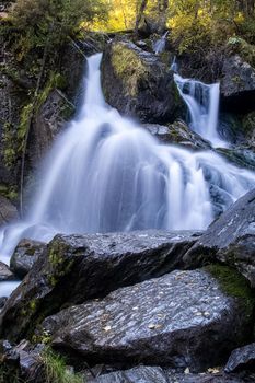 A small waterfall on a mountain river in the Altai. The Altai Mountain Rivers.