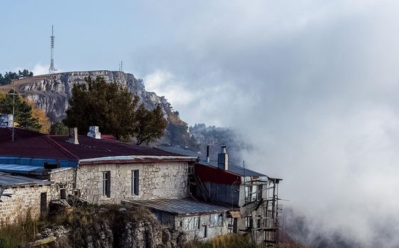 At home near the rocks. Stone houses in a mountain village. Crimea