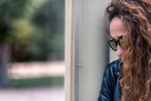 Attractive woman looking through the glass, relaxing.