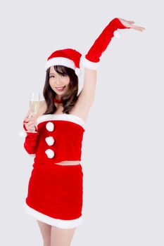 Beautiful portrait young asian woman in Santa holding glass of champagne with party celebrating in xmas holiday isolated on white background, asia girl drink beverage, Christmas and new year concept.