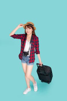 Beautiful young asian woman smiling and travel summer trip with luggage and holding hat for abroad in vacation, happy asia girl having camera walking and pull suitcase for journey in holiday.