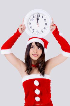 Beautiful portrait young asian woman in Santa dress holding clock with excited in xmas holiday isolated on white background, beauty asia girl celebrating success in festive Christmas day or new year.