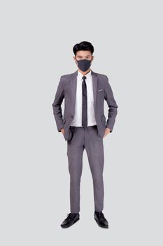 Portrait young asian businessman in suit wearing face mask for protective covid-19 isolated on white background, business man and healthcare, quarantine for pandemic coronavirus, new normal.