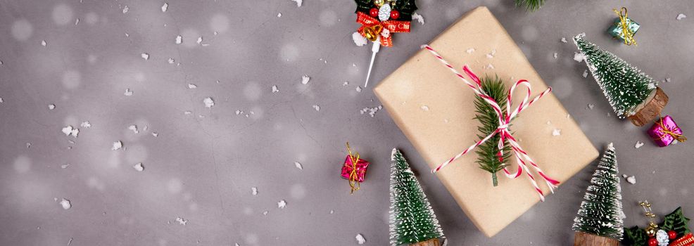 Christmas holiday composition with gift box and snow decoration, new year and xmas or anniversary with presents on cement floor background in season, top view or flat lay, copy space, banner website.