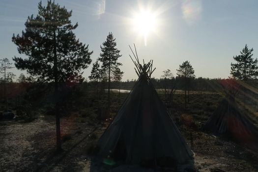 Yurt resident of the forest tundra and tundra. Yurt against the background of the forest and sunset.