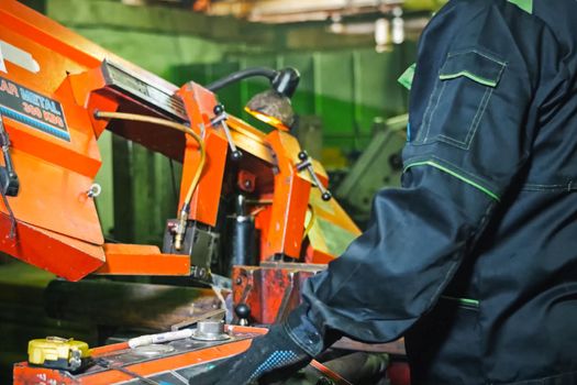 Moscow, Russia - January 23, 2019: The worker stands at the machine on the sharpening of parts.