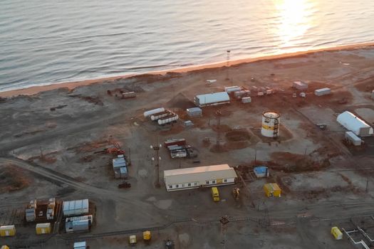 An oil field by the sea. service buildings and equipment.