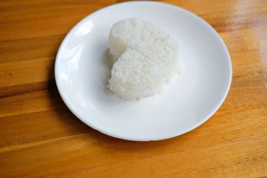 heart shaped steamed rice in white plate serving in restaurant