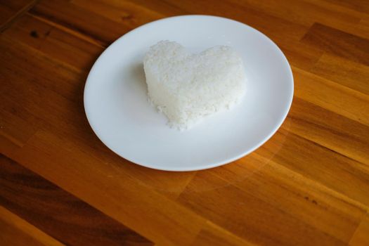 heart shaped steamed rice in white plate serving in restaurant