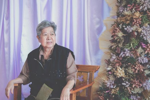 stressed depressed fatigued sad upset asian old asian elderly senior elder woman sitting at home