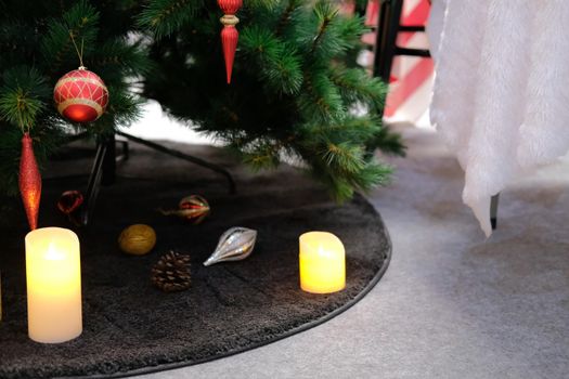 red christmas balls. festive ornament decoration. candle, conifer cone