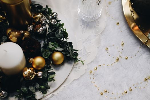 green leaves and christmas balls. festive ornament decoration. candle, conifer cone