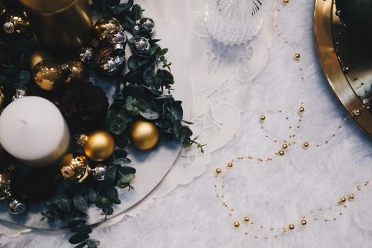 green leaves and christmas balls. festive ornament decoration. candle, conifer cone