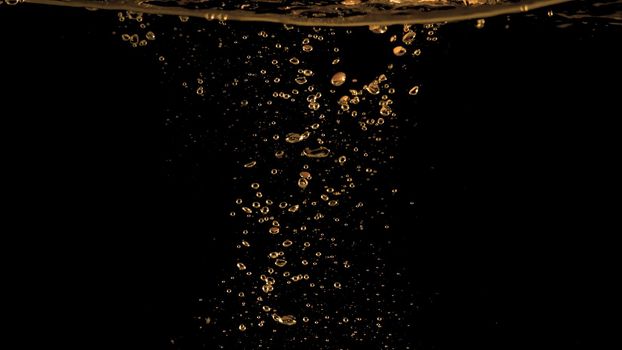Close up images of oil bubbles from diesel gasoline splashing and floating up to the air on black background for represent power of fuel liquid that active and powerful.