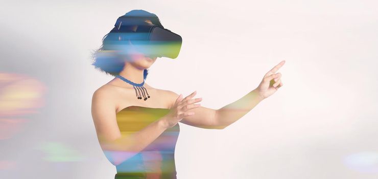 Asian teenage woman wearing VR or Virtual Reality head set and enter to the digital simulation world for learning and traveling or gaming  and more. Studio shot white background