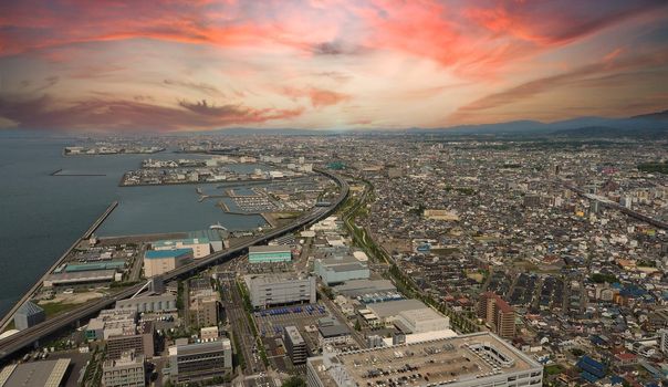 Aerial view or bird eyes view images of Kansai bay area Osaka Japan include big premium outlets located across from Kansai International Airport and it's largest airport in western Osaka bay Kansai Japan. 