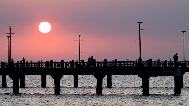 Bangsan Chonburi Thailand jetty and sunset. At Bangsan beach. Ao Thai Ocean. Beautiful sunset landscape, wooden shore jetty and colorful sky and cloud. Artistic beach sunset under wonderful sky. Recreation concept.