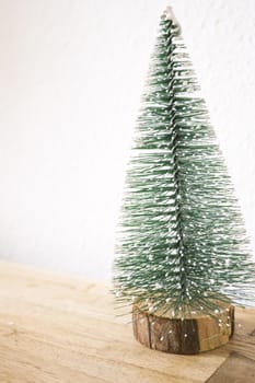 Green christmas tree on neutral background without decoration. No people