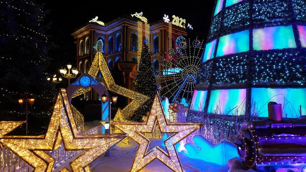 The city is decorated for Christmas and new year. Buildings, garlands, Christmas trees, fences and the square glow with different lights. People relax, enjoy the winter and holiday. Almaty, Kazakhstan