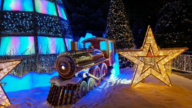 The city is decorated for Christmas and new year. Buildings, garlands, Christmas trees, fences and the square glow with different lights. People relax, enjoy the winter and holiday. Almaty, Kazakhstan