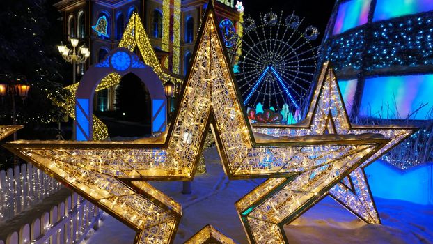 The city is decorated for Christmas and new year. Buildings, garlands, Christmas trees, fences and the square glow with different lights. People relax, enjoy the winter and holiday. Almaty, Kazakhstan