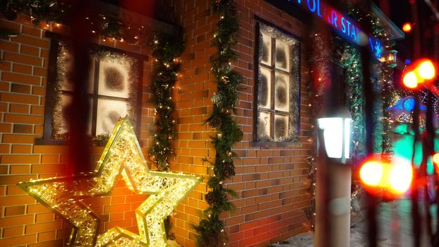 The city is decorated for Christmas and new year. Buildings, garlands, Christmas trees, fences and the square glow with different lights. People relax, enjoy the winter and holiday. Almaty, Kazakhstan