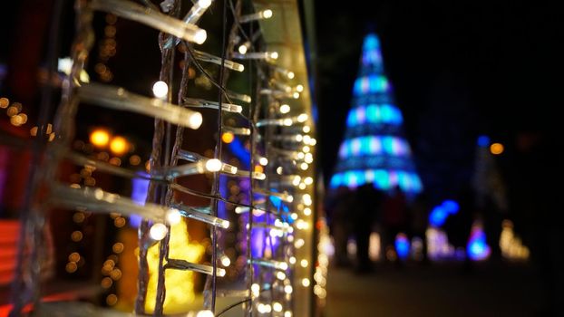 The city is decorated for Christmas and new year. Buildings, garlands, Christmas trees, fences and the square glow with different lights. People relax, enjoy the winter and holiday. Almaty, Kazakhstan