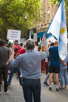2020-10-12, Mendoza, Argentina: During a protest against the national government, a man holds a sign the reads "Freedom. Justice. Respect."