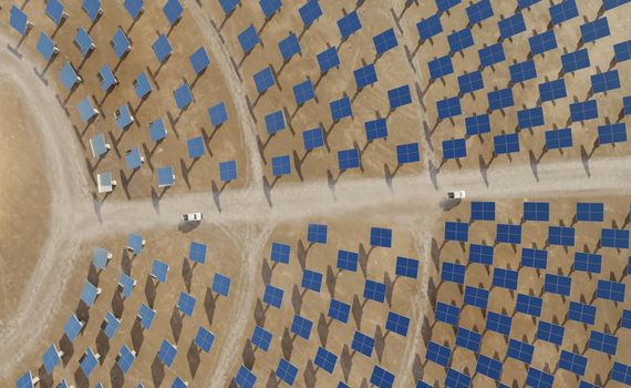 Solar energy plant with a circular array of collectors. Clean energy, modern technology concept. Digital 3D render. Top down view.