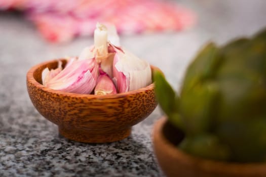 Garlic clives on a wooden bowl. Close up.