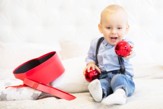 Blurred child holds a bright Christmas toy.