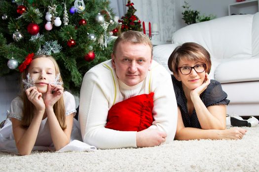 Ordinary family with christmas tree.