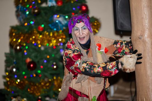 Baba Yaga on the background of the Christmas tree.