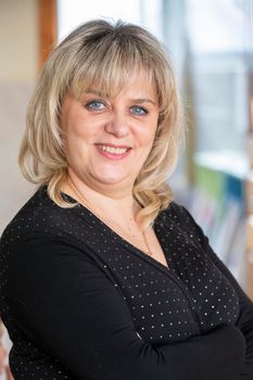 Vertical portrait of an ordinary forty-year-old woman.
