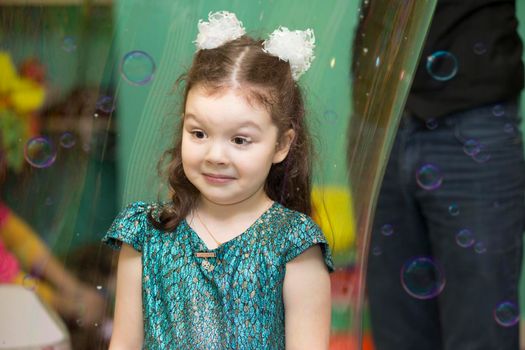 Belarus, Gomel, November 9, 2017. Gomel Children's Center.Girl inside a soap bubble at the show.