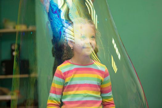 Belarus, Gomel, November 9, 2017. Gomel Children's Center.Girl inside a soap bubble at the show.