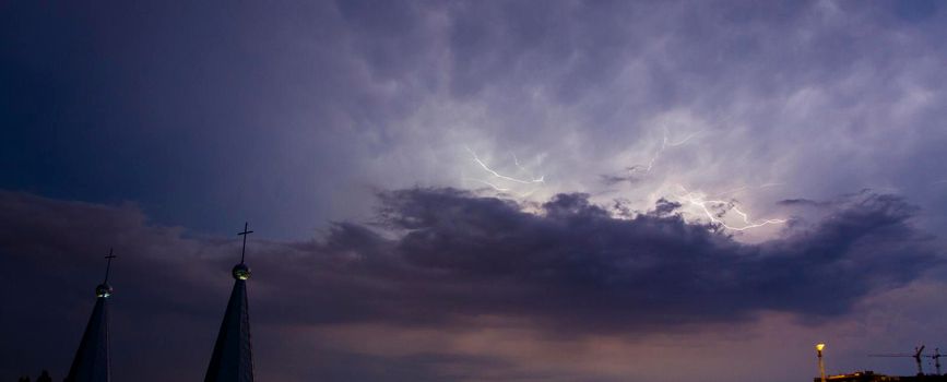 The towers of the church with crosses in a thunderstorm. Thunderclouds, lightning and church.