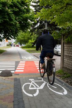 UKRAINE, LUTSK - May 10, 2020: Man riding on bike at the city street on a bike path
