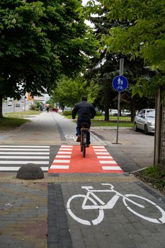 UKRAINE, LUTSK - May 10, 2020: Man riding on bike at the city street on a bike path