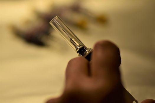 close-up of a hand holding an injection